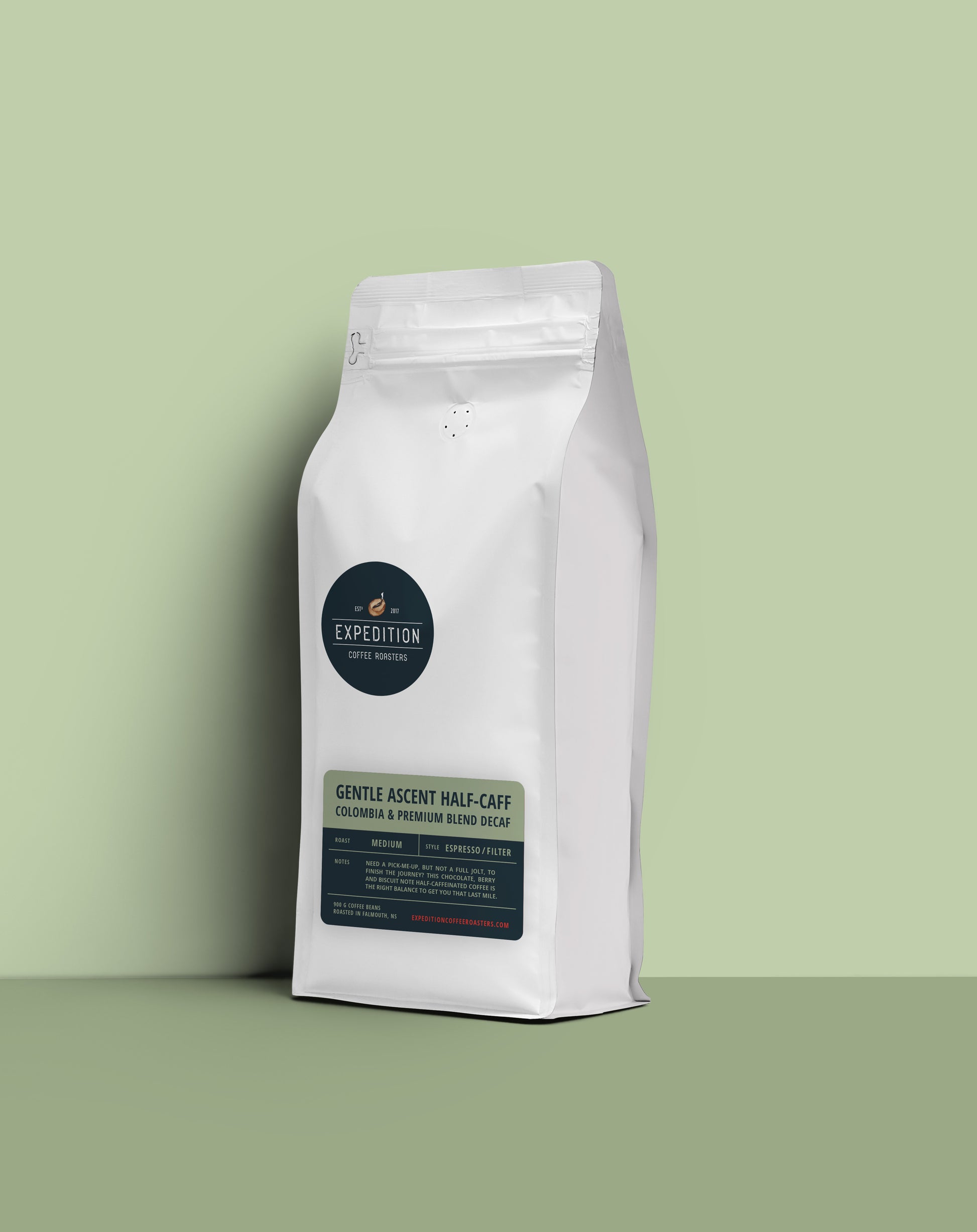 Gentle Ascent half-caff coffee beans in a white coffee bag with a label on a light green background